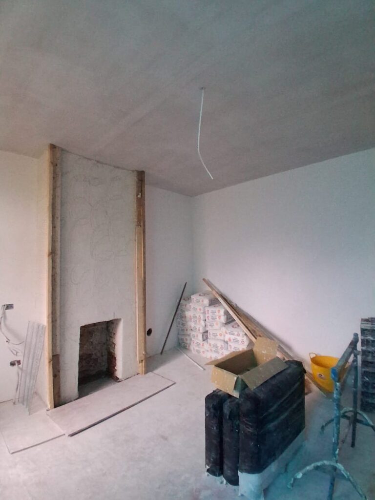 Plastered living room with chimney breast ready for finishing